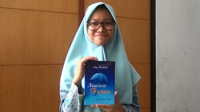 
Aisy Nadira (17) menunjukkan buku karyanya